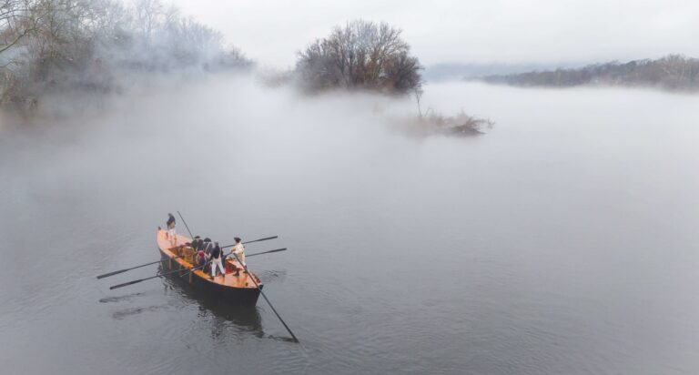 a boat on a river covered in mist