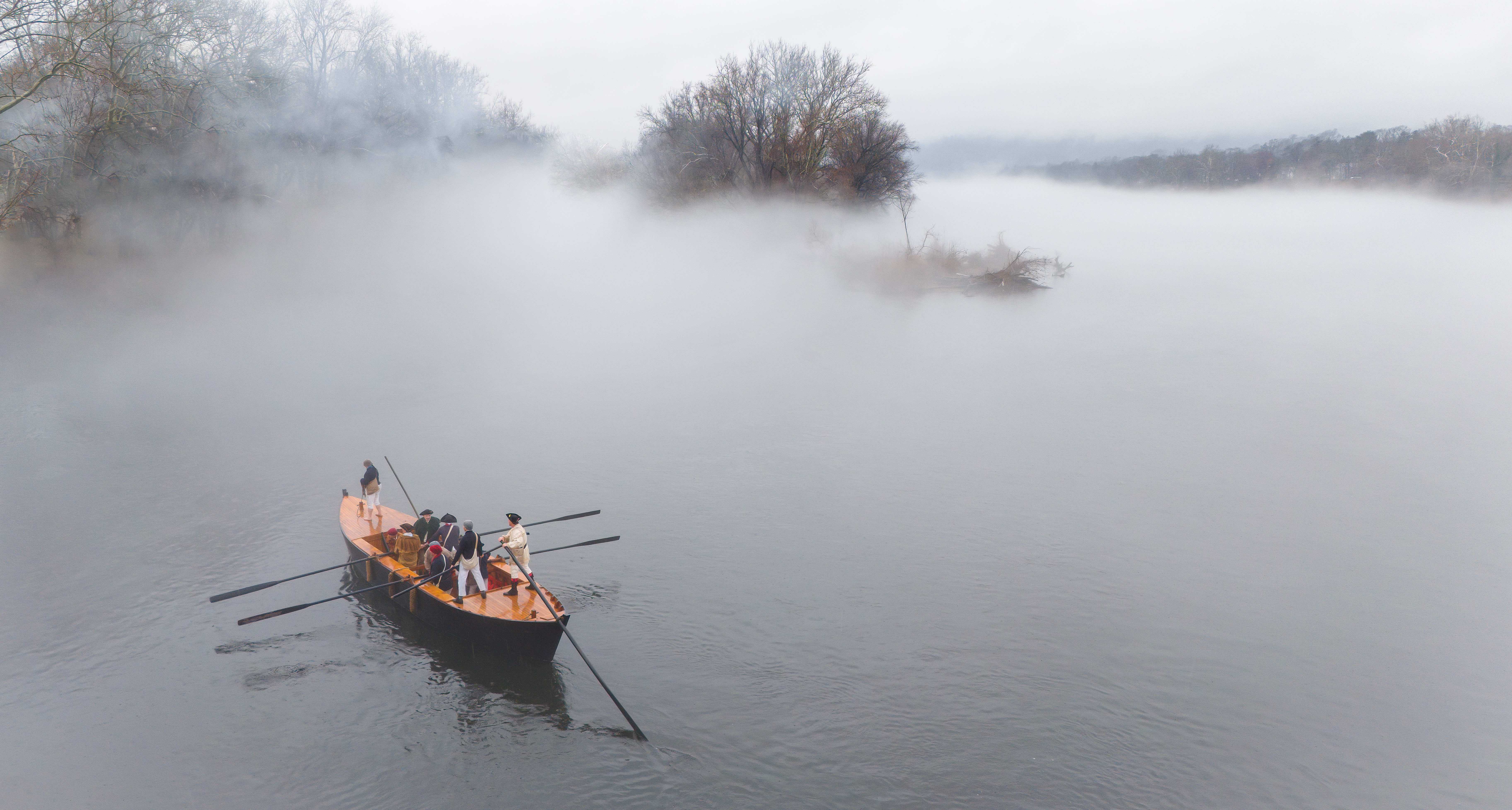 a boat on a river covered in mist