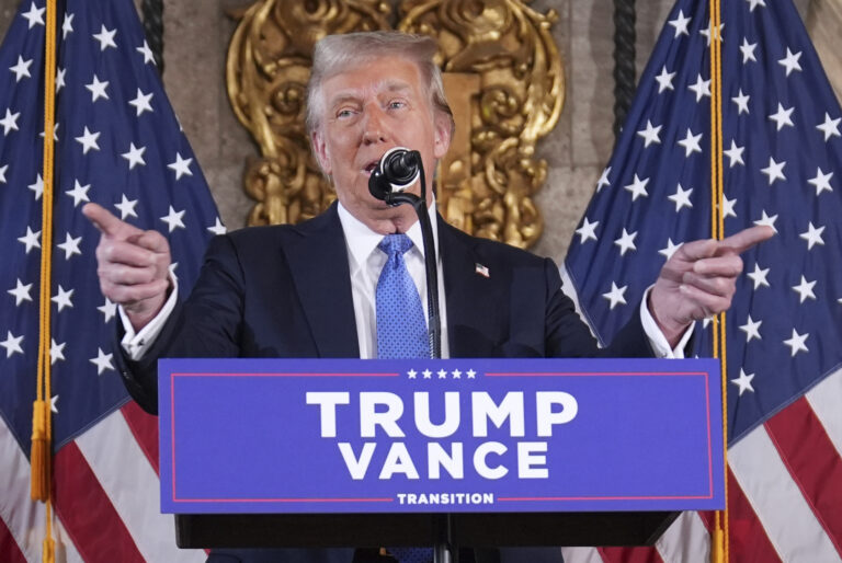 Donald Trump points his fingers and speaks