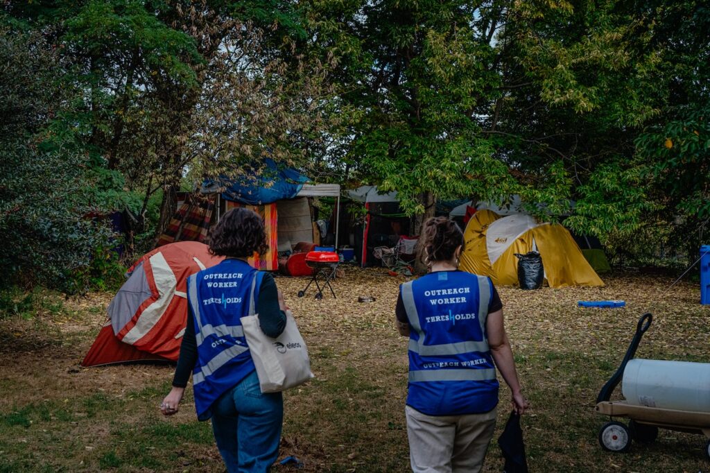 homeless-encampments-npr-2024-12-26-01 Outreach workers walking into a homeless encampment
