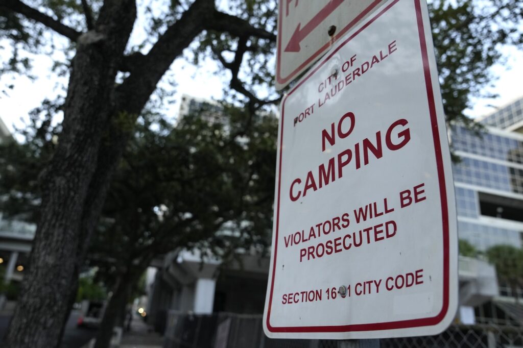 A sign says 'No Camping'