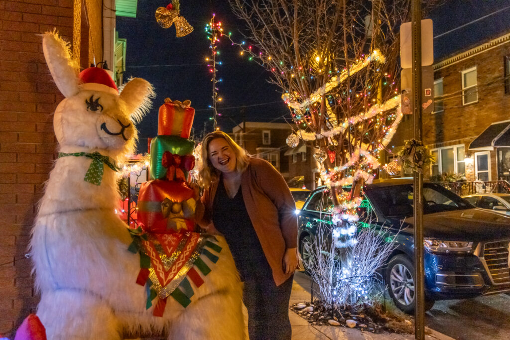 miracle-13th-street-2024-12-20 Zoe Fox with her beloved holiday llama