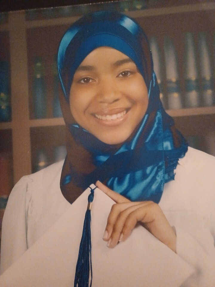 Wilson-Anton posing for a photo at her high school graduation