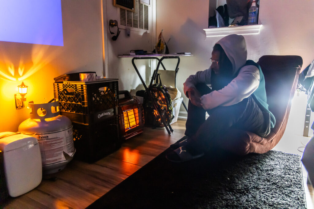 01 06 2025 k paynter no heat locust tower apartments-8 Naim Scott sitting in the apartment with the propane heater running