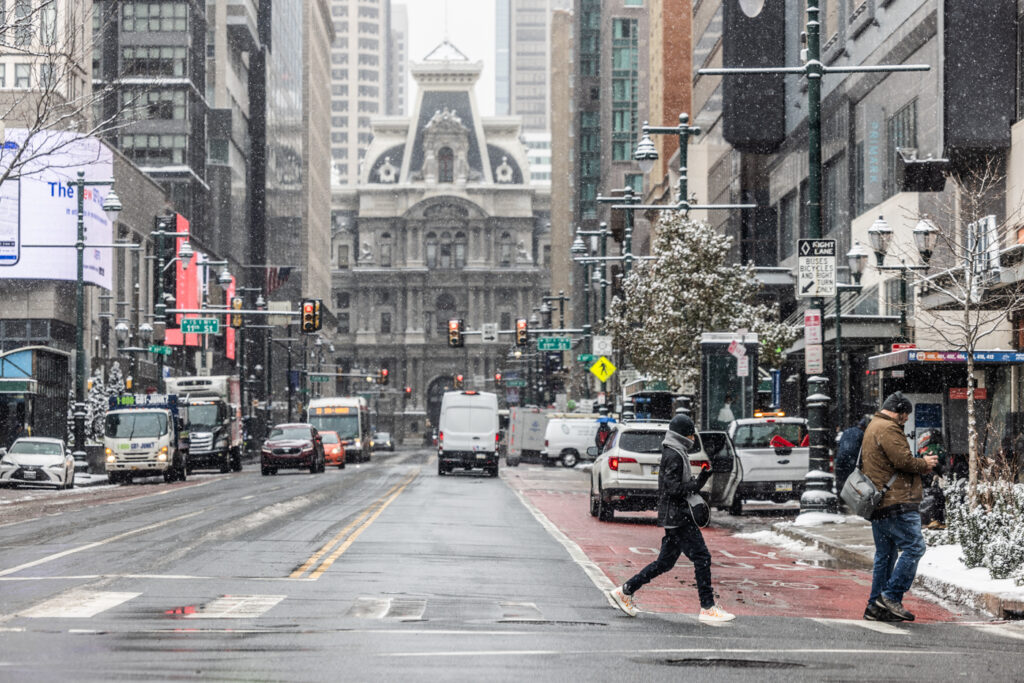 01 06 2025 k paynter snow january 6 2025-2 two people cross the street near City Hall