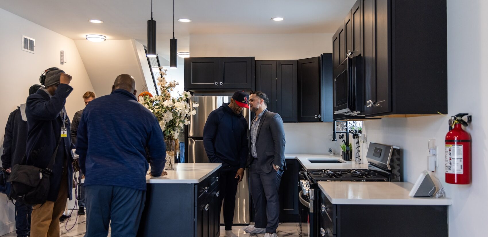 People touring the kitchen in the new home