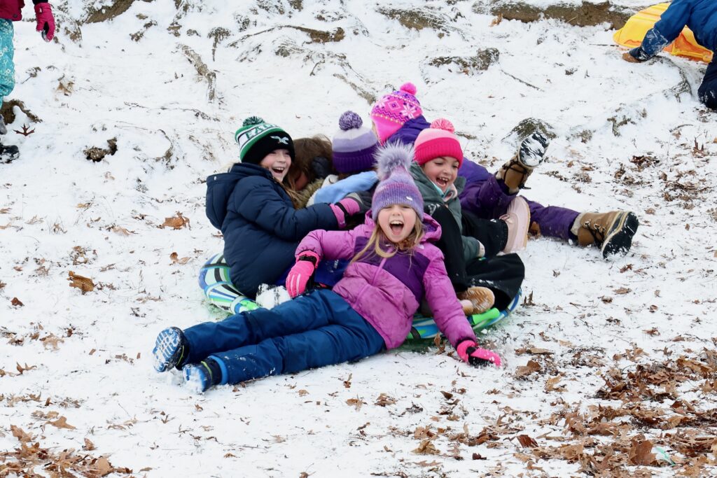 2025 01 06-e lee- moorestown nj-snow day sledders A group of children playing in the snow on sleds