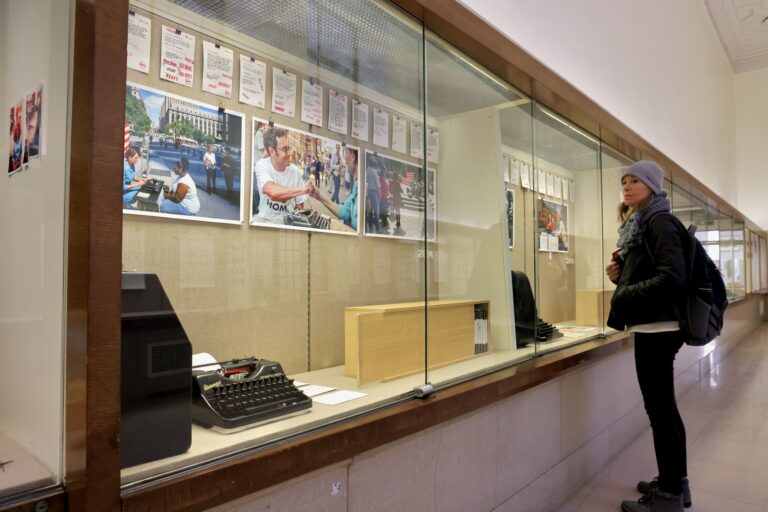 Photos and typewriters are shown in a display