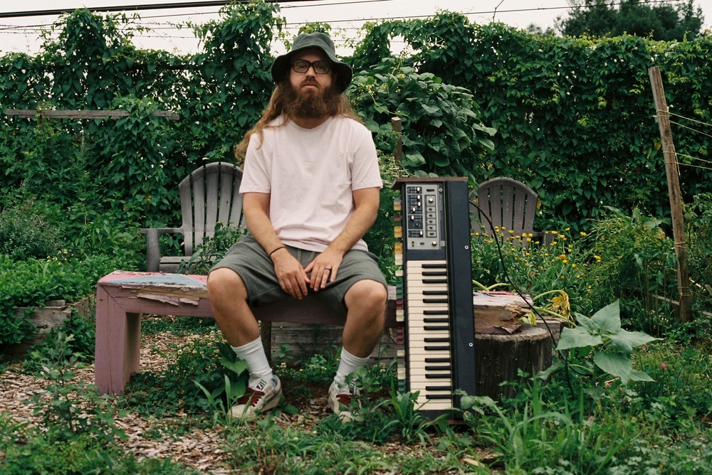 Corey-Bernhard-A-Blessed-Leap-Into-Eternity-3 Corey Bernhard sitting outside with a keyboard