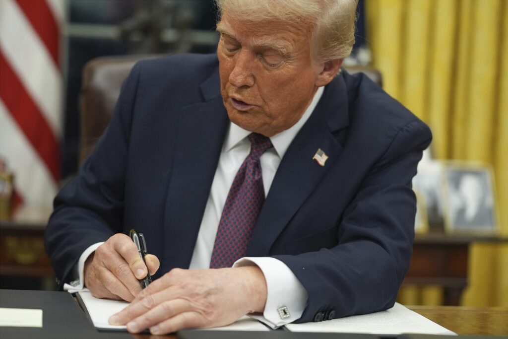 Donald Trump Donald Trump signing an executive order at his desk