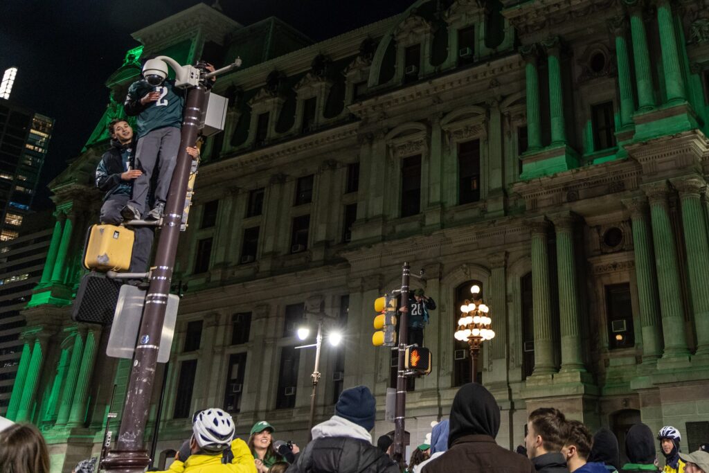 eagles-beat-commanders-fans-philadelphia-2025-01-26-3 Two fans on a street light