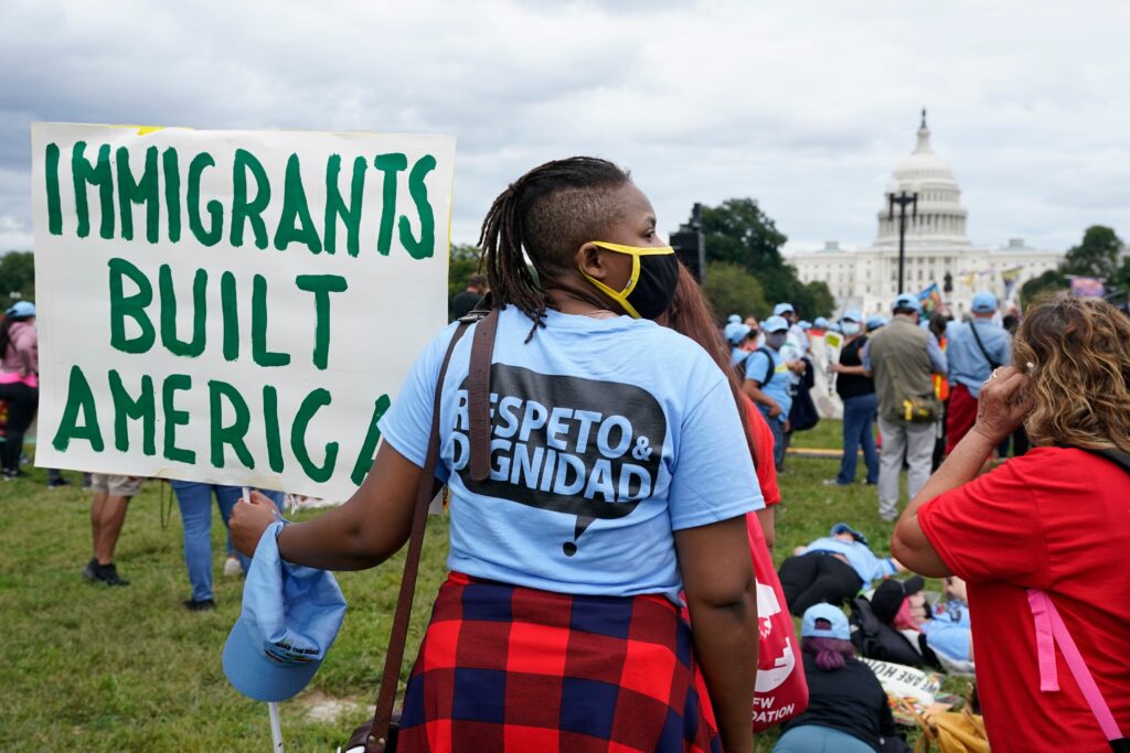 immigration-protest-2021-09-21 a person holds a sign reading IMMIGRANTS BUILT AMERICA