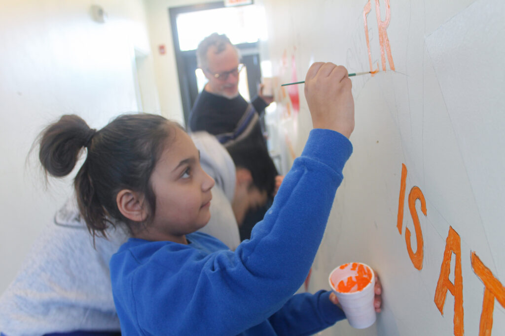 live-and-learn-paint-affordable-housing-philadelphia-2025-01-25-5 a child painting