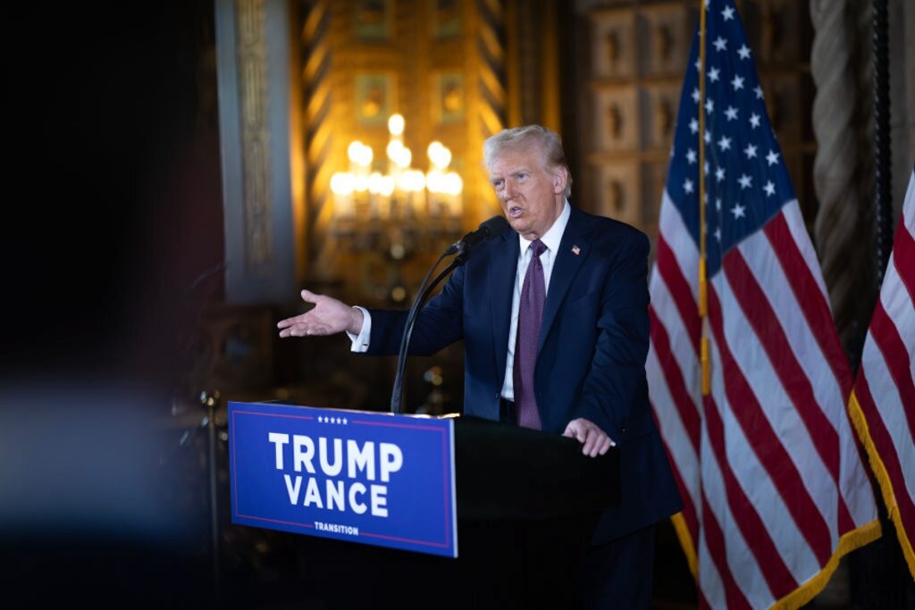 President-Elect Trump Holds Press Conference At Mar-A-Lago Donald Trump speaking at a podium