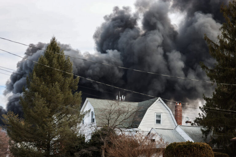 Black smoke rising in the sky from the fire