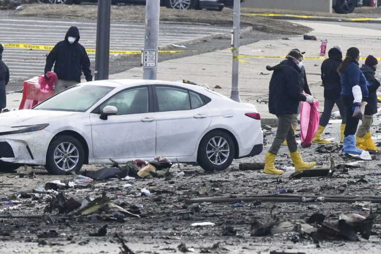 Investigators on the ground at the site of the plane crash