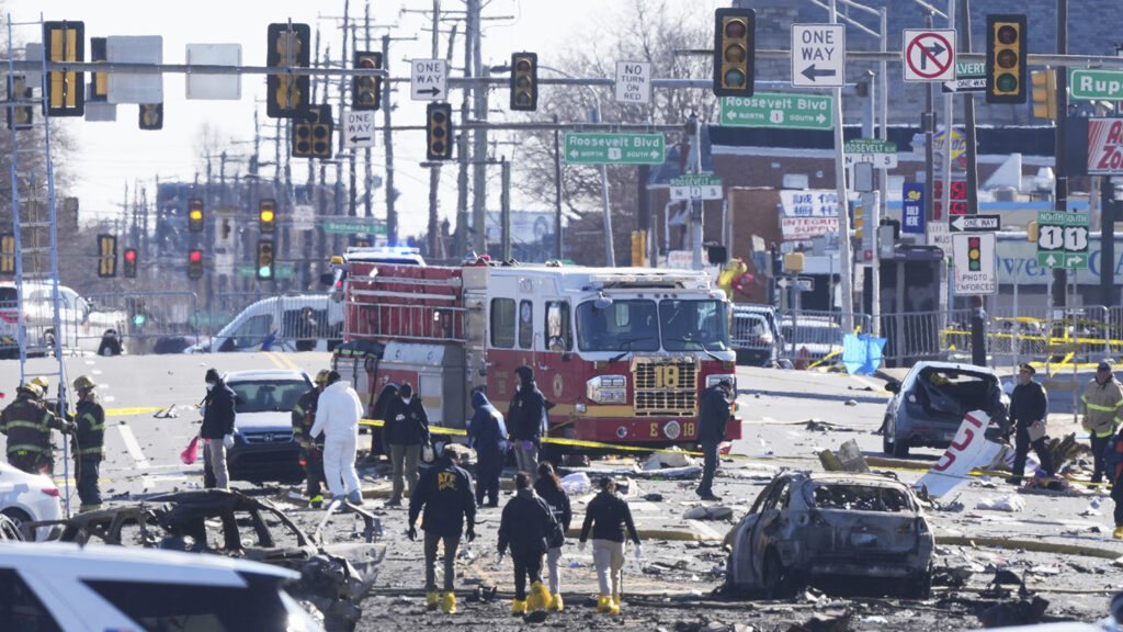 Investigators on the ground at the site of the plane crash