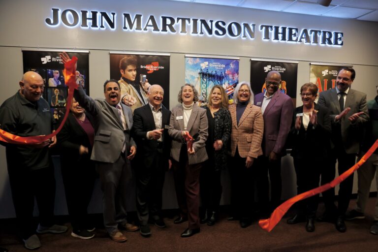 Amy Kaissar cuts a ribbon alongside others