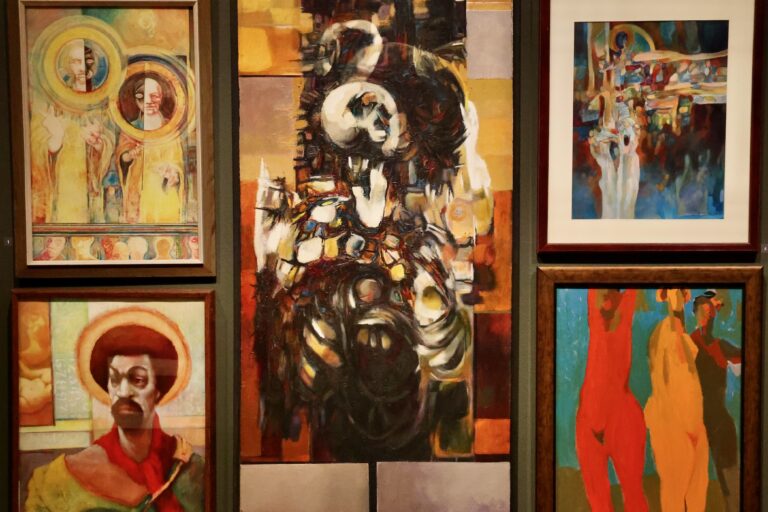 Multiple pieces of art hanging up in the exhibit
