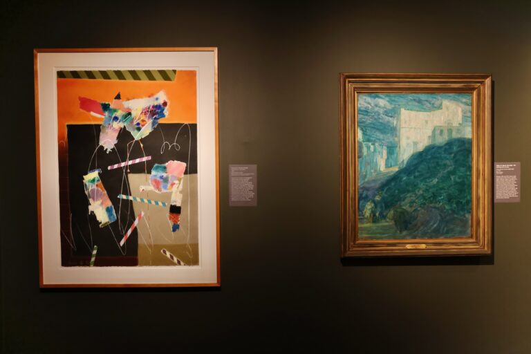 2 paintings hung up on a wall in an exhibit