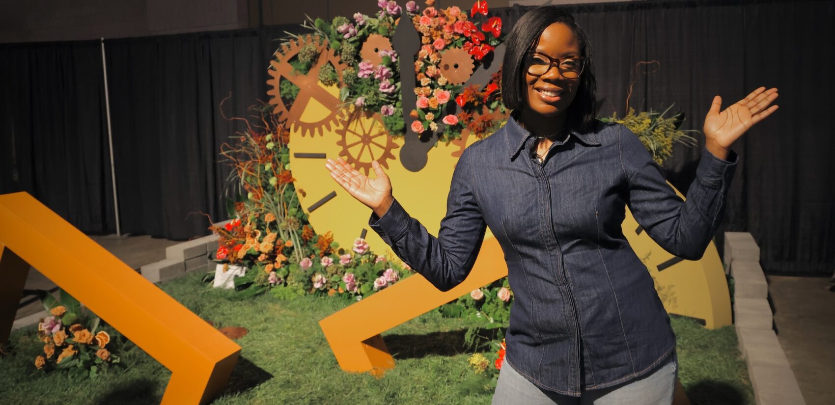 Rashawn Scarbo posing in front of a floral design