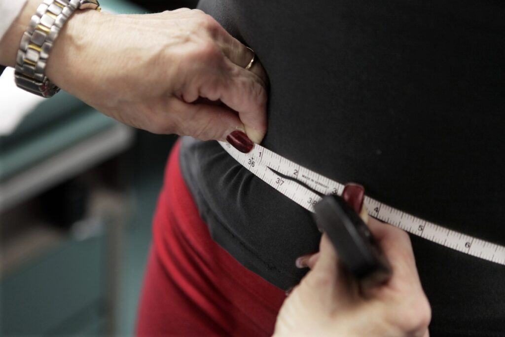 Off The Charts-Obesity Treatment Market FILE - In this Jan. 20, 2010 file photo, a subject's waist is measured during an obesity prevention study in Chicago. Obesity rates in the U.S. have been rising steadily for well over a decade and some of the world’s biggest drug developers are tapping into the growing treatment market. Novo Nordisk reported another surge in profits and revenue during its most recent quarter with a big assist from Wegovy, an injectable treatment for weight loss approved by the Food and Drug Administration in 2021. (AP Photo/M. Spencer Green, File)