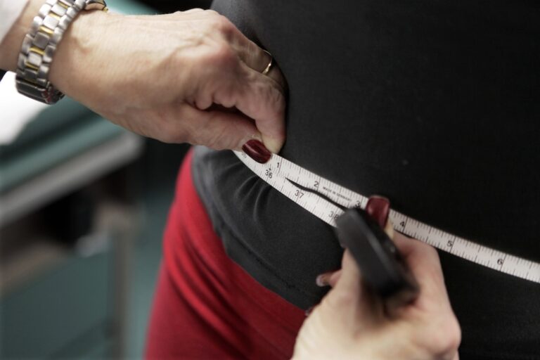 FILE - In this Jan. 20, 2010 file photo, a subject's waist is measured during an obesity prevention study in Chicago. Obesity rates in the U.S. have been rising steadily for well over a decade and some of the world’s biggest drug developers are tapping into the growing treatment market. Novo Nordisk reported another surge in profits and revenue during its most recent quarter with a big assist from Wegovy, an injectable treatment for weight loss approved by the Food and Drug Administration in 2021. (AP Photo/M. Spencer Green, File)