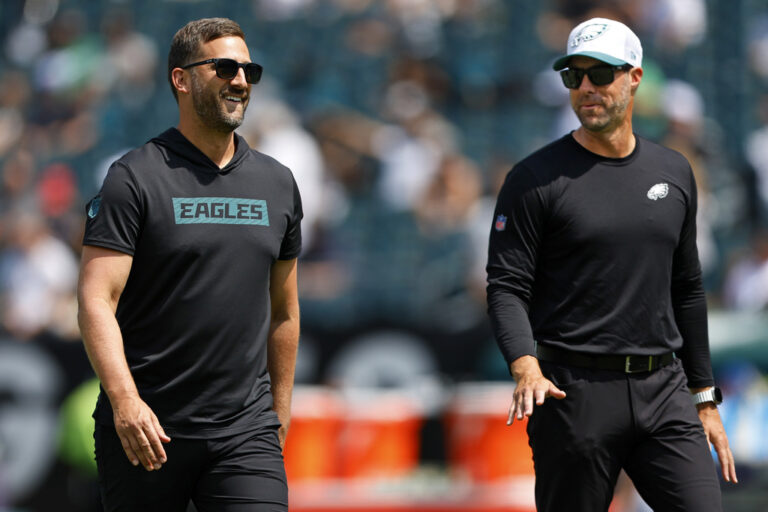 FILE - Philadelphia Eagles head coach Nick Sirianni, left, talks with assistant head coach Kevin Patullo during warmups before an NFL pre-season football game against the Minnesota Vikings, Saturday, Aug.24, 2024, in Philadelphia. (AP Photo/Rich Schultz, File)