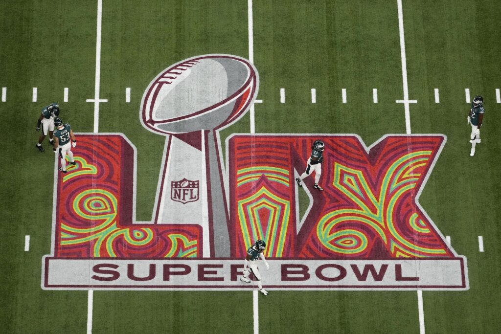 Eagles players warm up on the field before Super Bowl 59