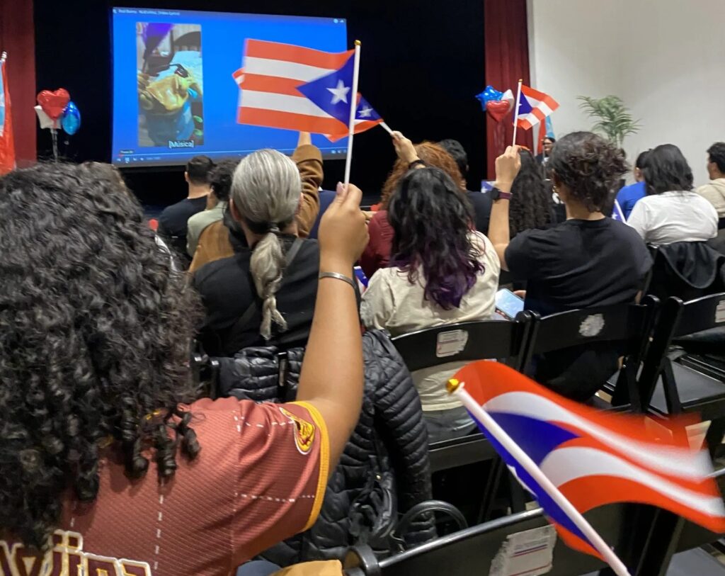 bad-bunny-philly-event-2025 people hold Puetro Rican flags at an event