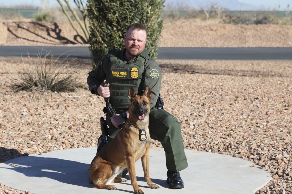 Vermont Border Patrol Shooting Border Patrol Agent David Maland posing with a service dog