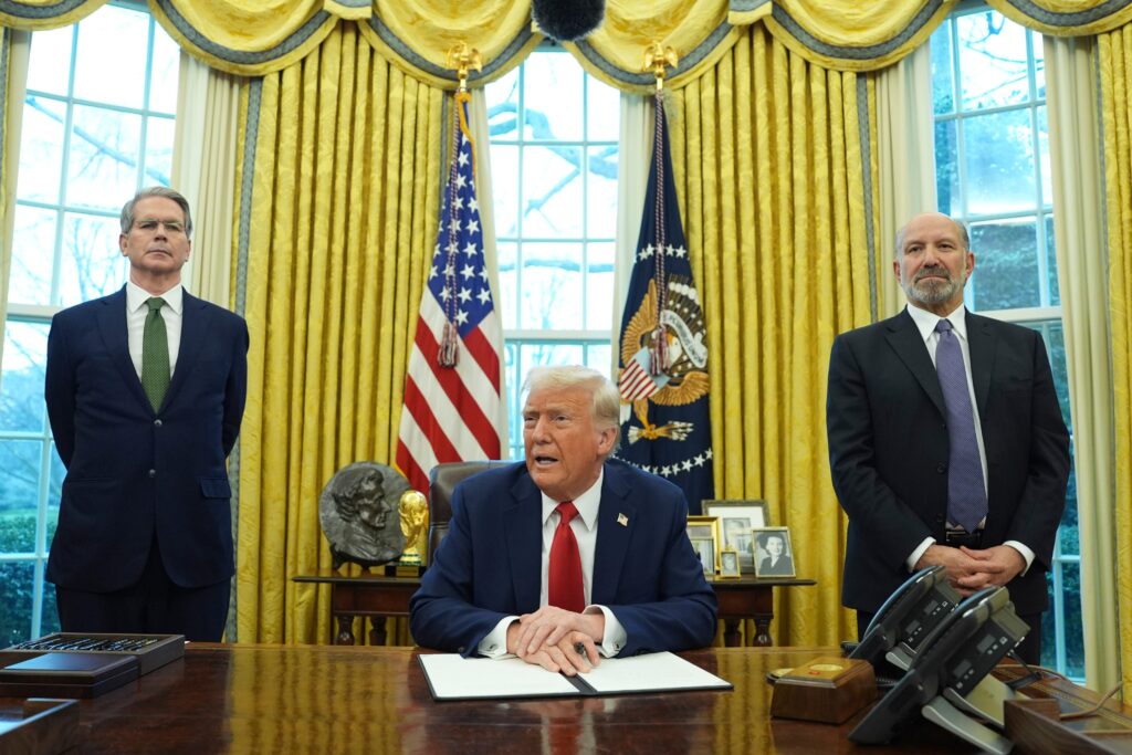 donald-trump-2025-02-03 Donald Trump sitting while Scott Bessent and Howard Lutnick stand