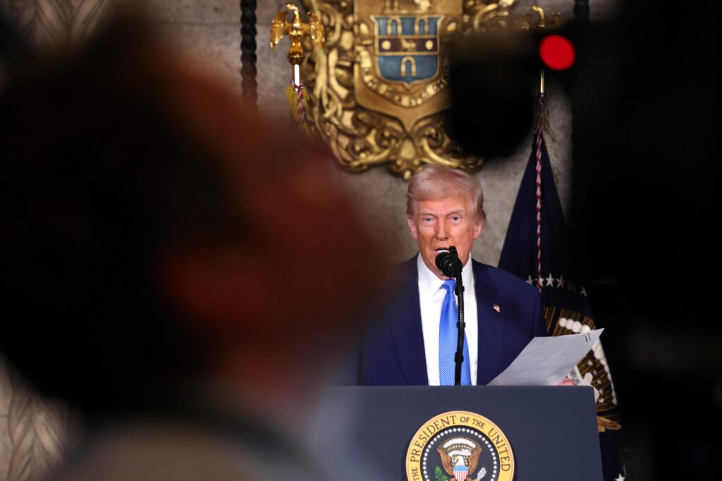 Donald Trump speaks in a microphone