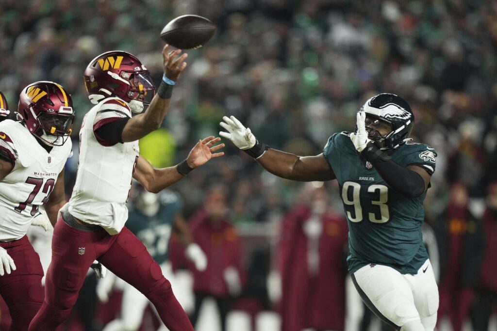 Commanders Eagles Football Commanders QB Jayden Daniels is pressured by Eagles defensive tackle Milton Williams