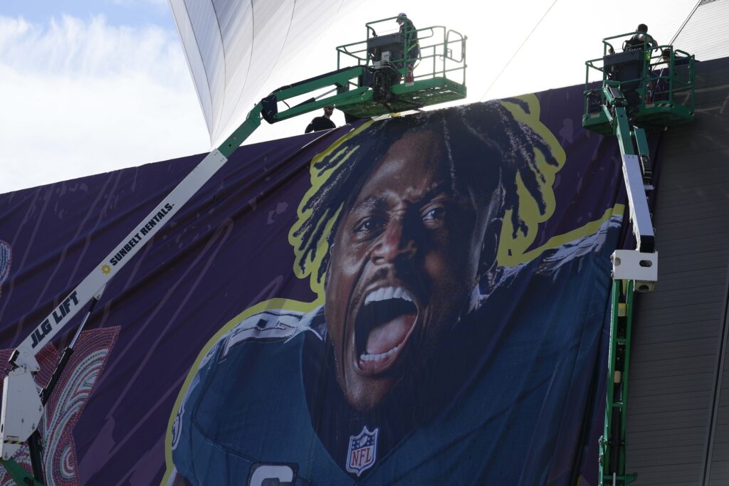 Super Bowl Football Workers hanging up banners outside the stadium