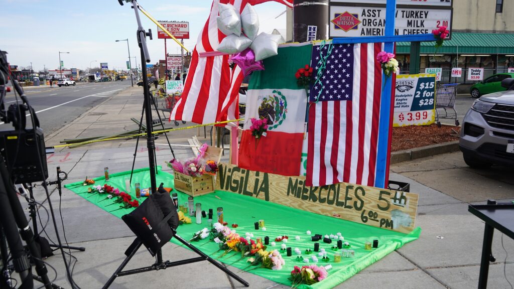 northeast-philadelphia-plane-crash-site-2025-02-03-2 a memorial on the sidewalk for Nigilia Miekcoles 5th, with flags, flowers and candles