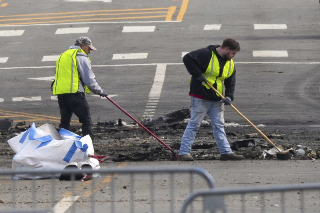 Philadelphia Small Plane Crash Workers sweeping debris