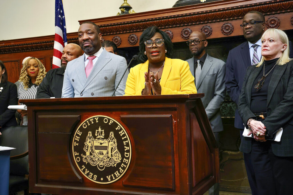 parker-brooks-housing-t-macdonald-2025-02-19-1 Cherelle Parker speaking at a podium surrounded by other officials