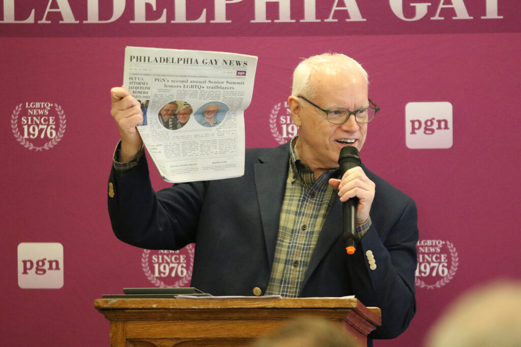 philadelphia_gay_news_awards02202025 Ed Miller held up Thursday's copy of the Philadelphia Gay News with the front page story of the Elder Initiative at the William Way LGBT Community Center being honored during the LGBTQ Senior Summit. (Cory Sharber/WHYY)
