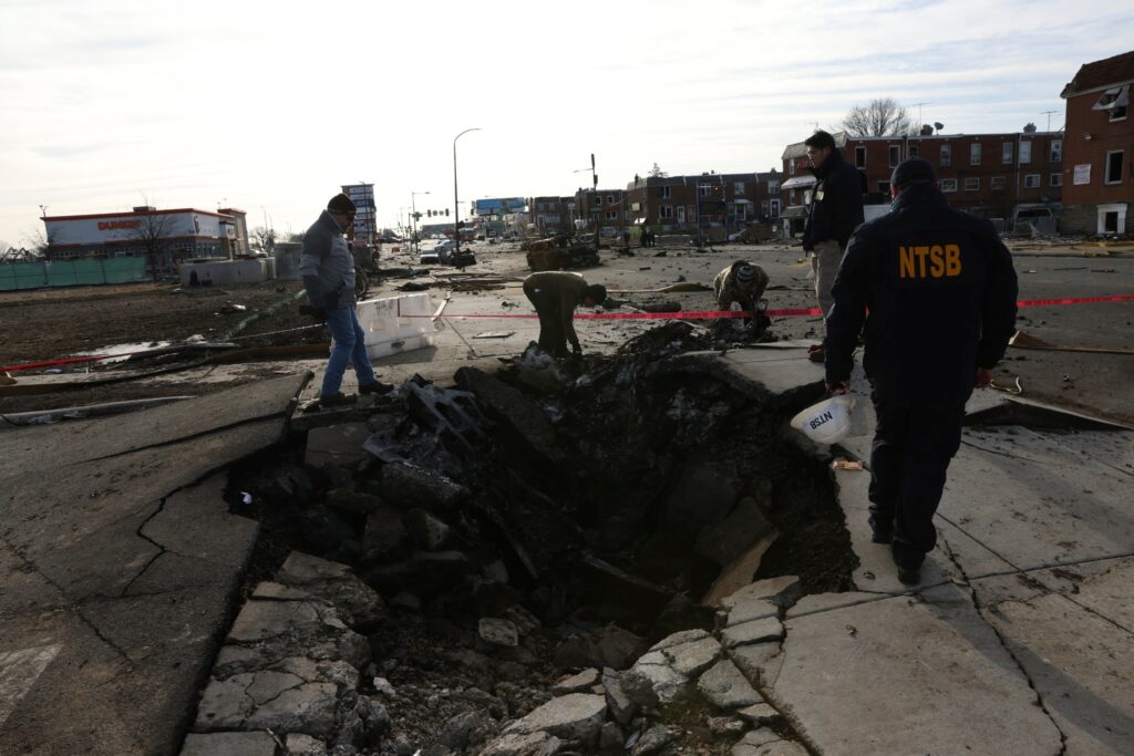 pladelphia-plane-crash-remnants-2025-02-04 a hole in the ground from the plane crash