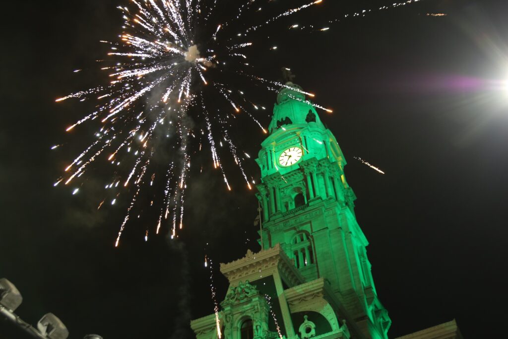 super-bowl-broad-street-c-sharber-2025-02-09-10 Fireworks over CIty Hall which is lit up in green light