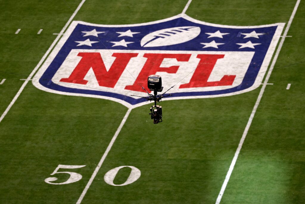 super-bowl-nfl-logo-field-2023 The NFL logo on the field and a camera seen in the air