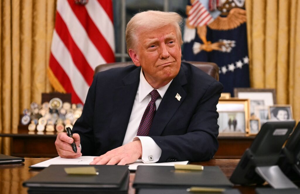 TOPSHOT-US-POLITICS-TRUMP-INAUGURATION President Trump signs executive orders in the Oval Office of the White House on Jan.20. (JIM WATSON/AFP via Getty Images/AFP)