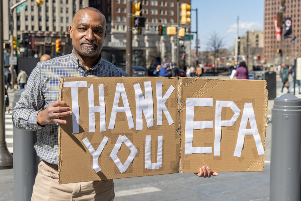 Brad Starnes holds a sign reading THANK YOU EPA