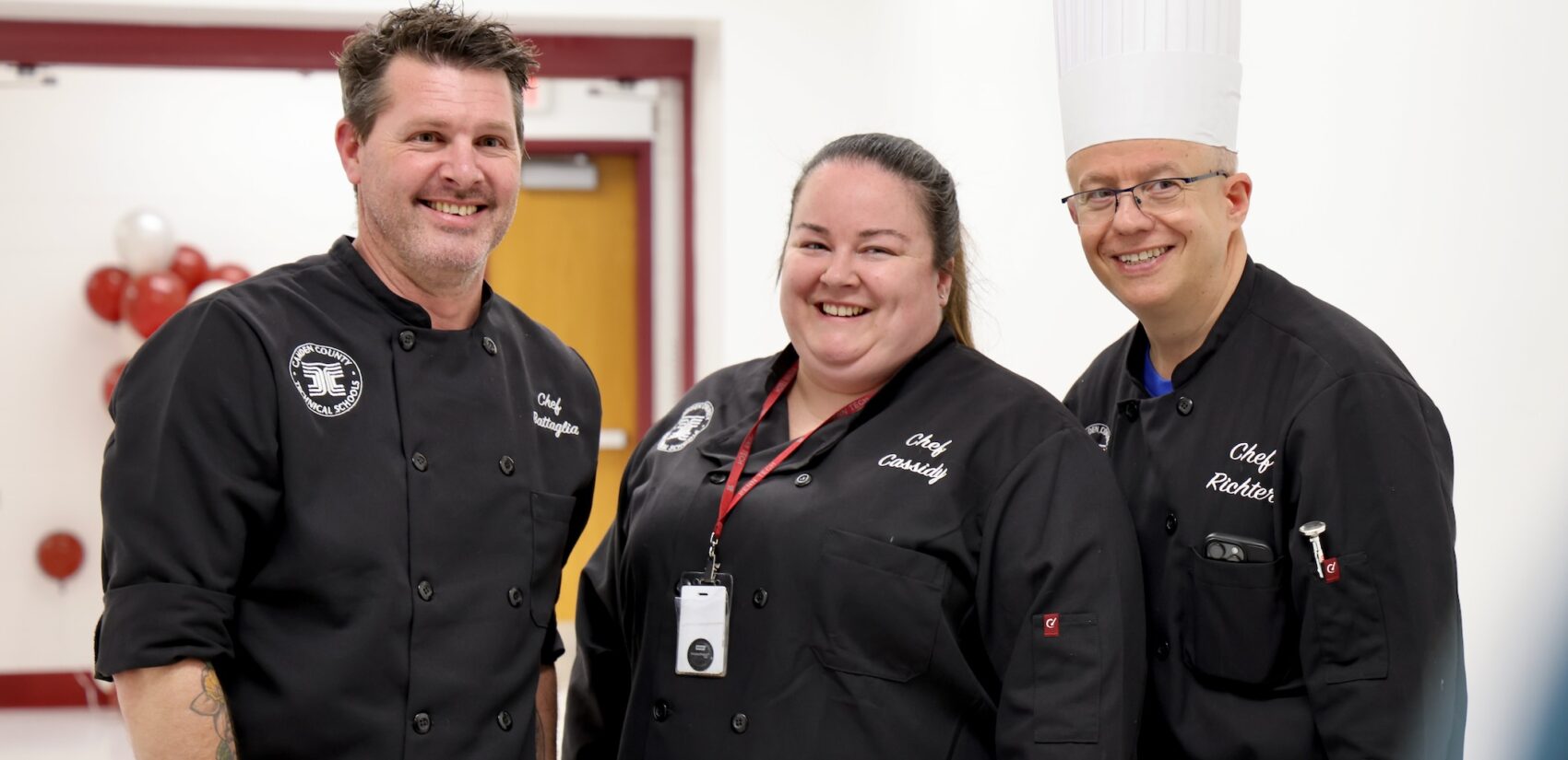 Three chefs posing for a photo