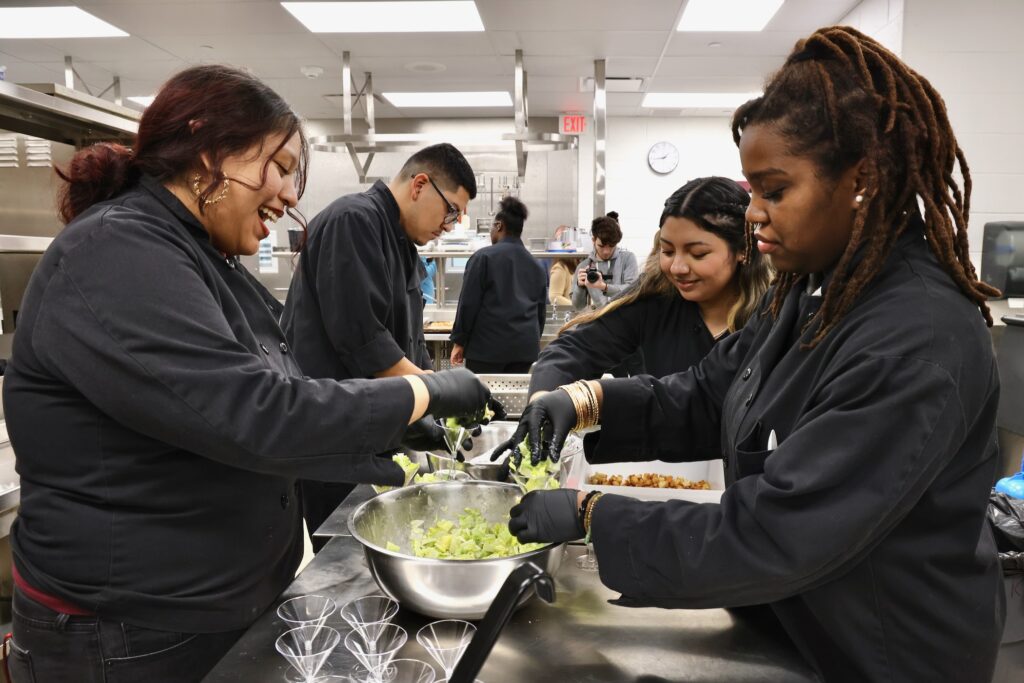 2025 02 27-e lee-pennsauken nj county technical schools-expansion students salad Several people working together on a salad in a kitchen