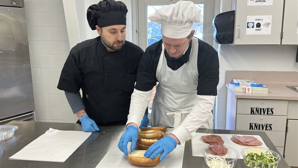 Two people prepare sandwiches at the Burlington County Library