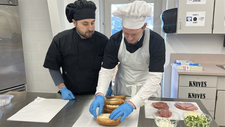 Two people prepare sandwiches at the Burlington County Library