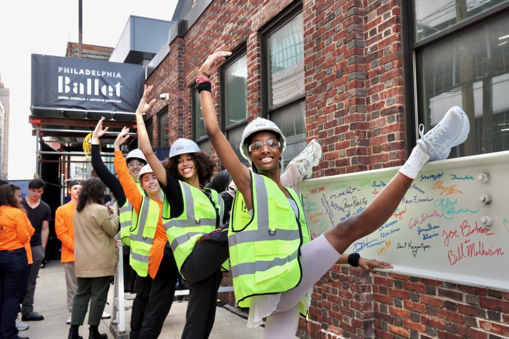 2025 03 12-e lee-philadelphia philadelphia ballet-expansion dancers Dancer trainees at the Philadelphia Ballet use a steel girder as a barre during a topping off ceremony for the company's 48,000-square-foot addition to its building on North Broad Street.