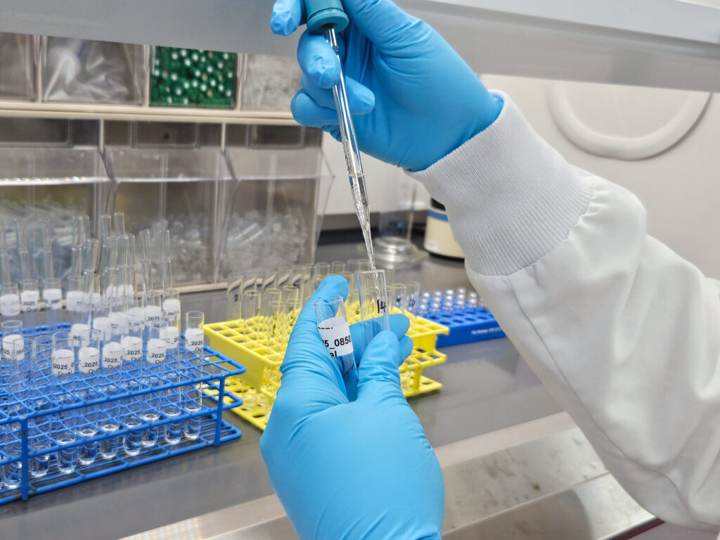 Alexis Quinter squeezing liquid in a vile into a tube